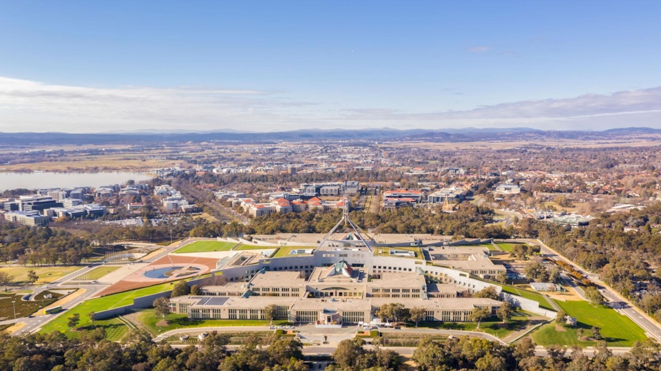 Aerial view of Australia’s Parliament House in Canberra, reflecting government fiscal policy and national debt.